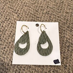Green Suede Triangular Accessory (Brand Not Visible)